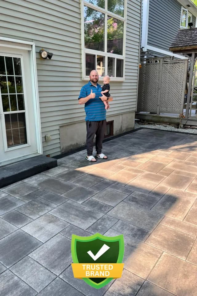 Homeowner shaking hands with Pedra crew after driveway completion
