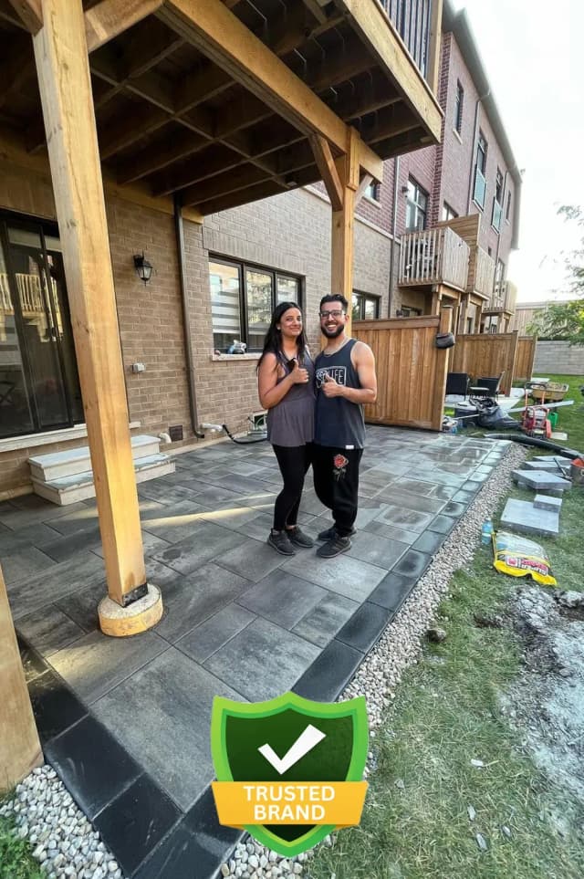 Happy couple reviewing finished landscape design with Pedra team